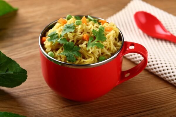 Red color maggie bowl filled with maggie