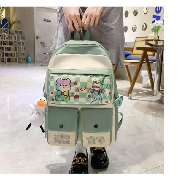 Green color fancy school bag for kids in girls hand