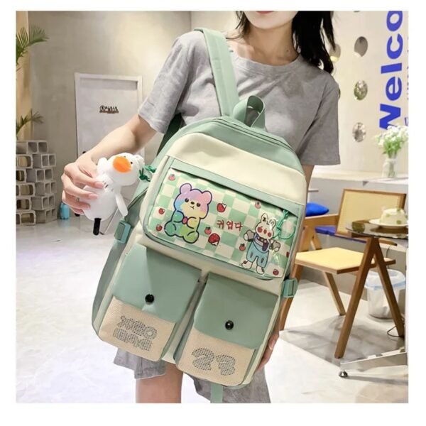 Green color backpack hanging on girls shoulder