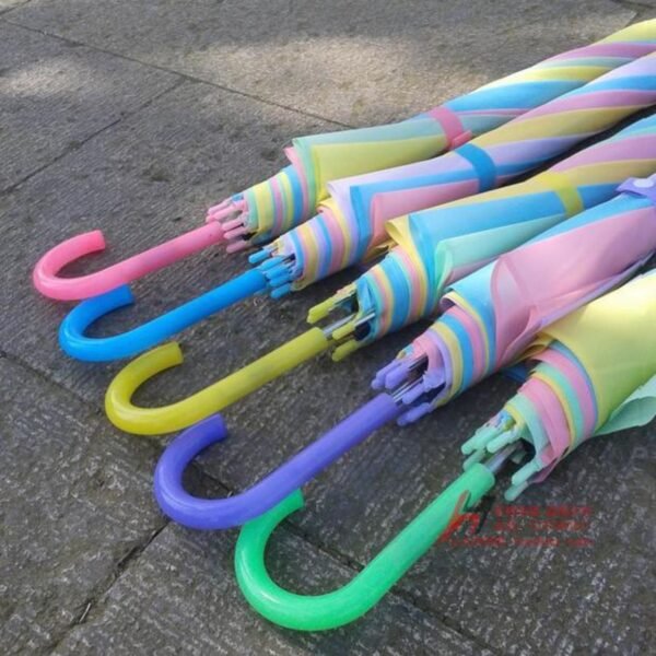 Five colorful striped umbrellas with pink, blue, yellow, purple and green handles.