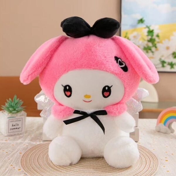 Kawaii Theme Soft Toy with pink hood, black bow, and heart eyes, sitting on a decorative table.